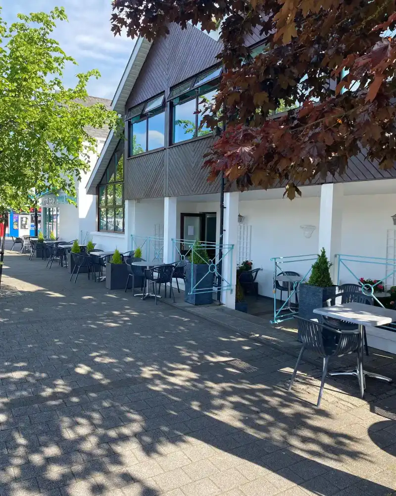 Outdoor terrace seating area at Coffey's with views of the town