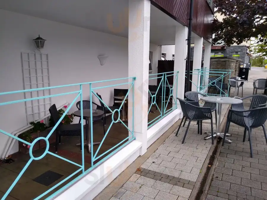 Coffey's terrace with turquoise railings and seating